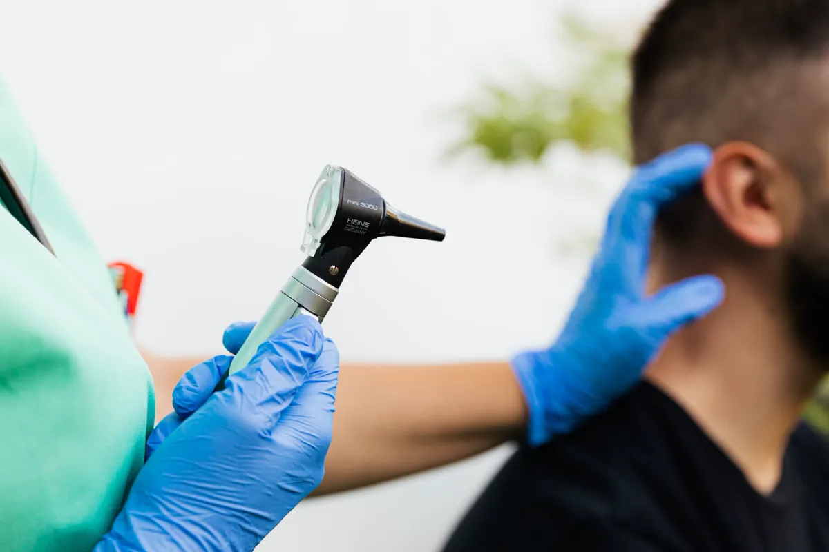 A doctor checking a patient's ear