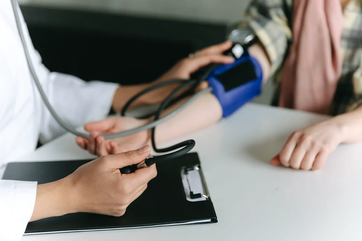 A doctor taking a patient's blood pressure
