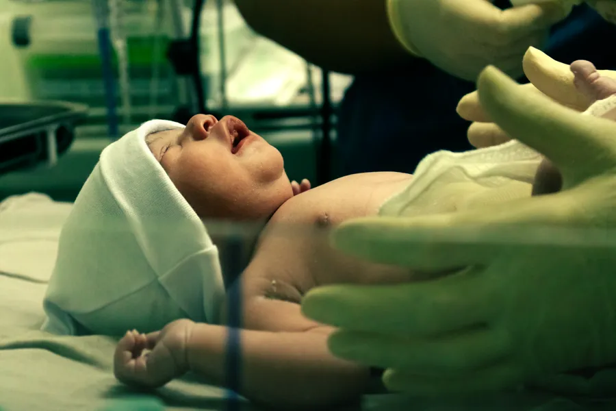 A newborn being cared for in the nursery